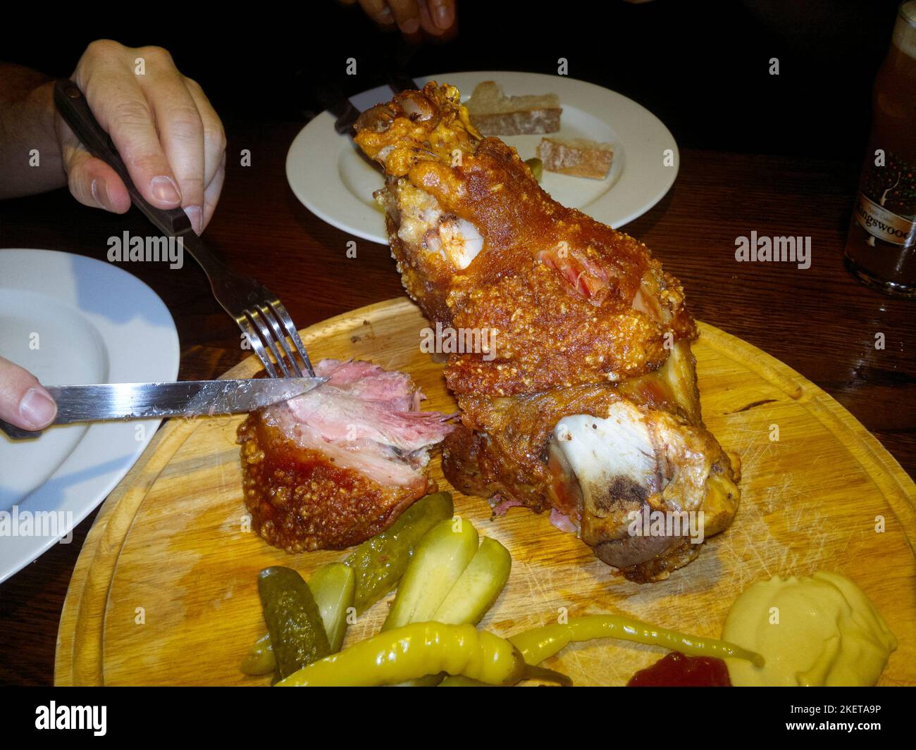 Brno, Moravia, Czech Republic : Eating Roasted pork knee (koleno) Czech food Stock Photo