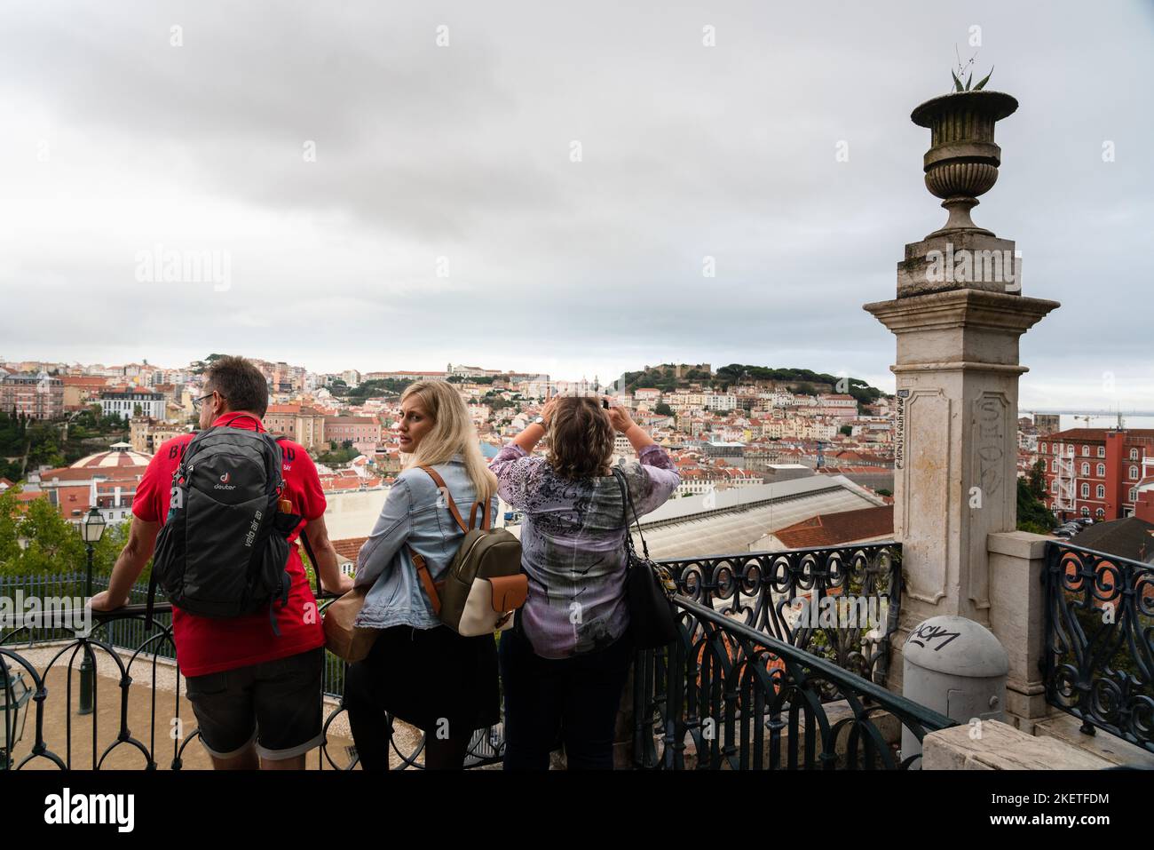 Tourists at the Miradouro de São Pedro de Alcântara in Lisbon, Portugal. This large terraced mirador offers panoramic views of the city. Stock Photo