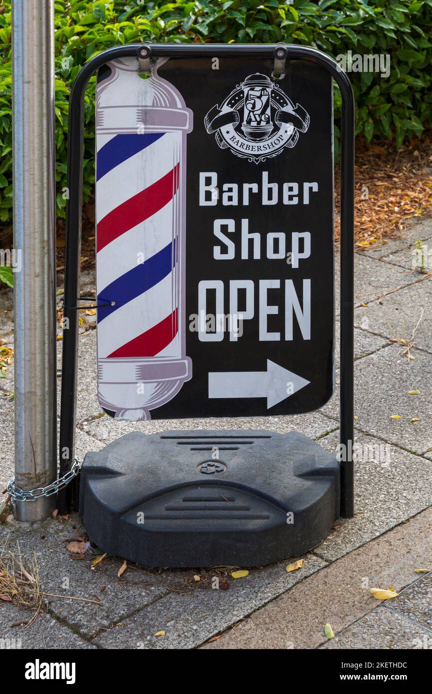 Barber Shop open sign barbers pole at Milton Keynes, Buckinghamshire, UK in September Stock Photo