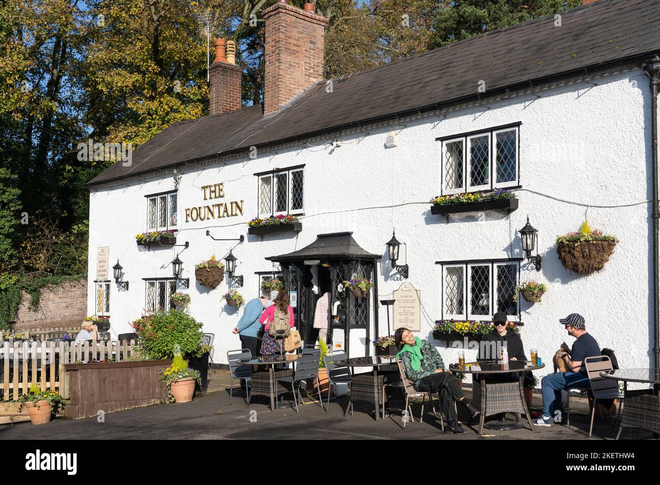 People sitting outside The Fountain at Clent, a traditional country