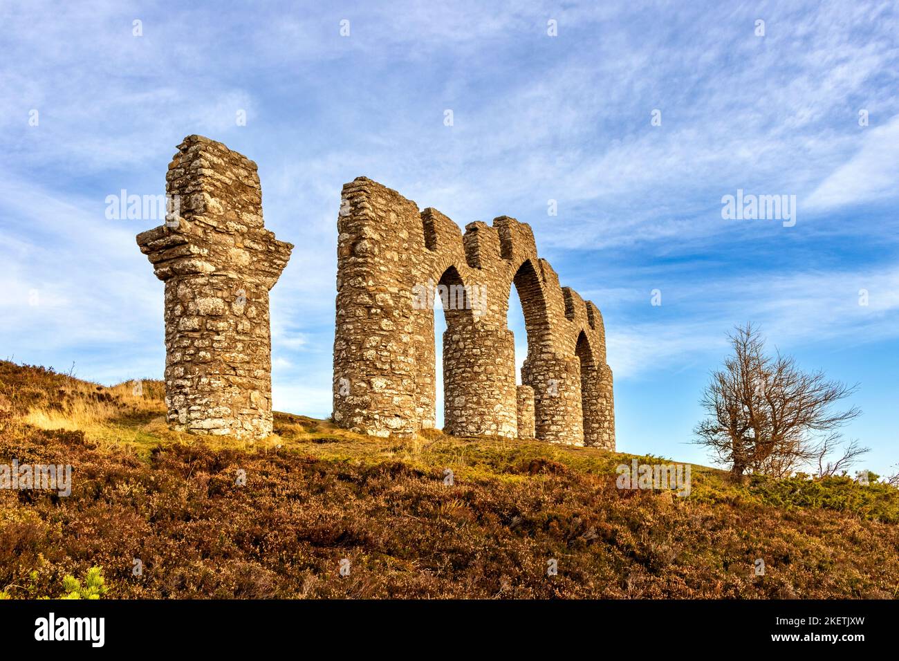 Fyrish Monument Alness Scotland stone monument blue sky and autumnal heather Stock Photo