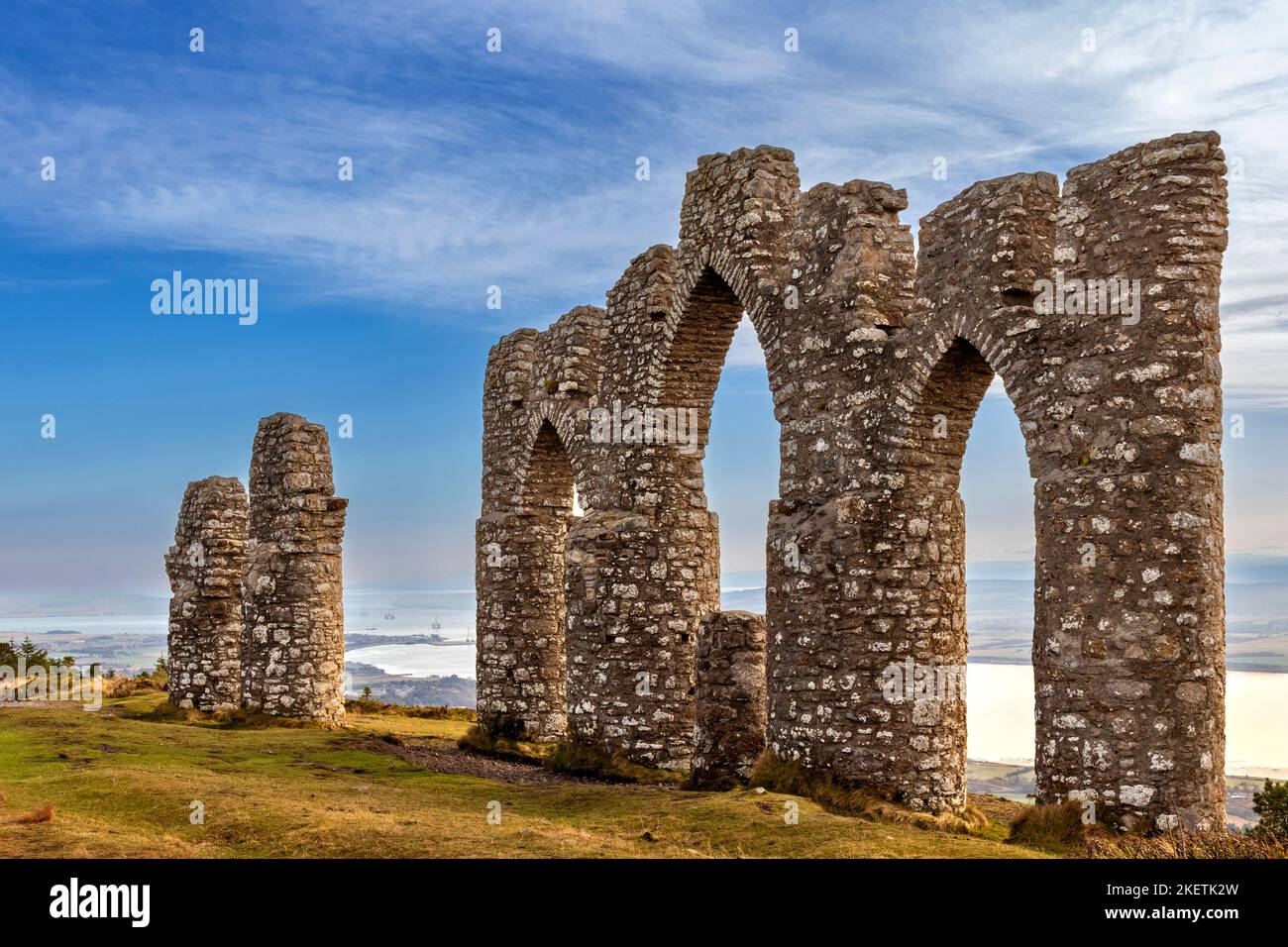 Fyrish Monument Alness Scotland the structure in autumn and a view of oil rigs in the Cromarty Firth Stock Photo