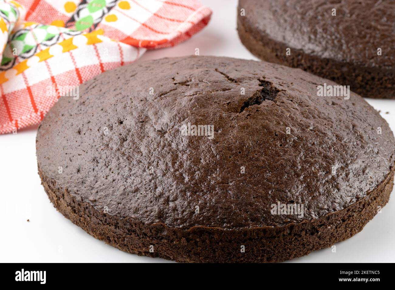 An English cake in a baking dish on a wooden board and a white wooden  table. Selective focus Stock Photo - Alamy