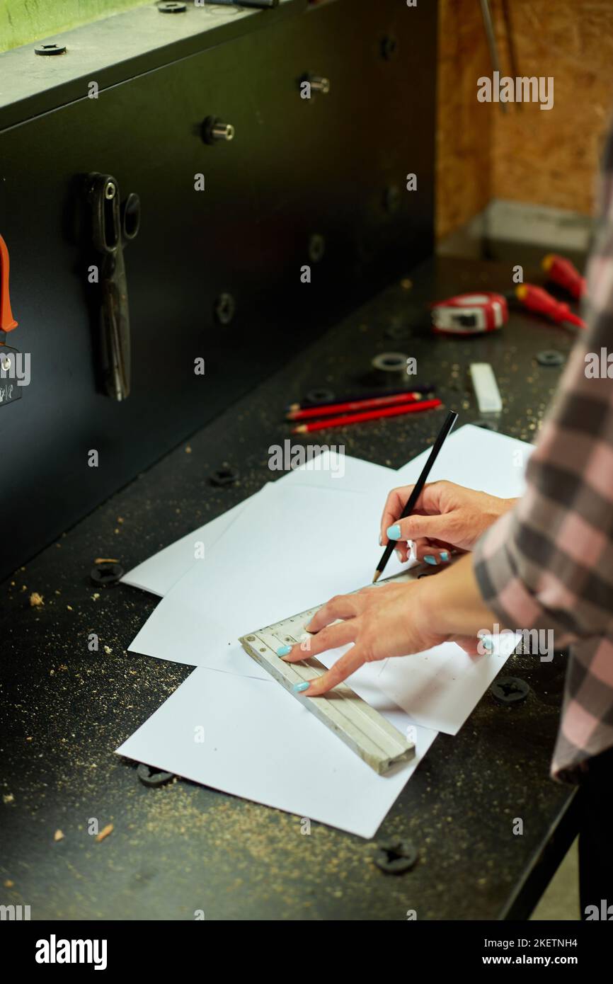 Female interior designer working on drawings, woman architect draws ...