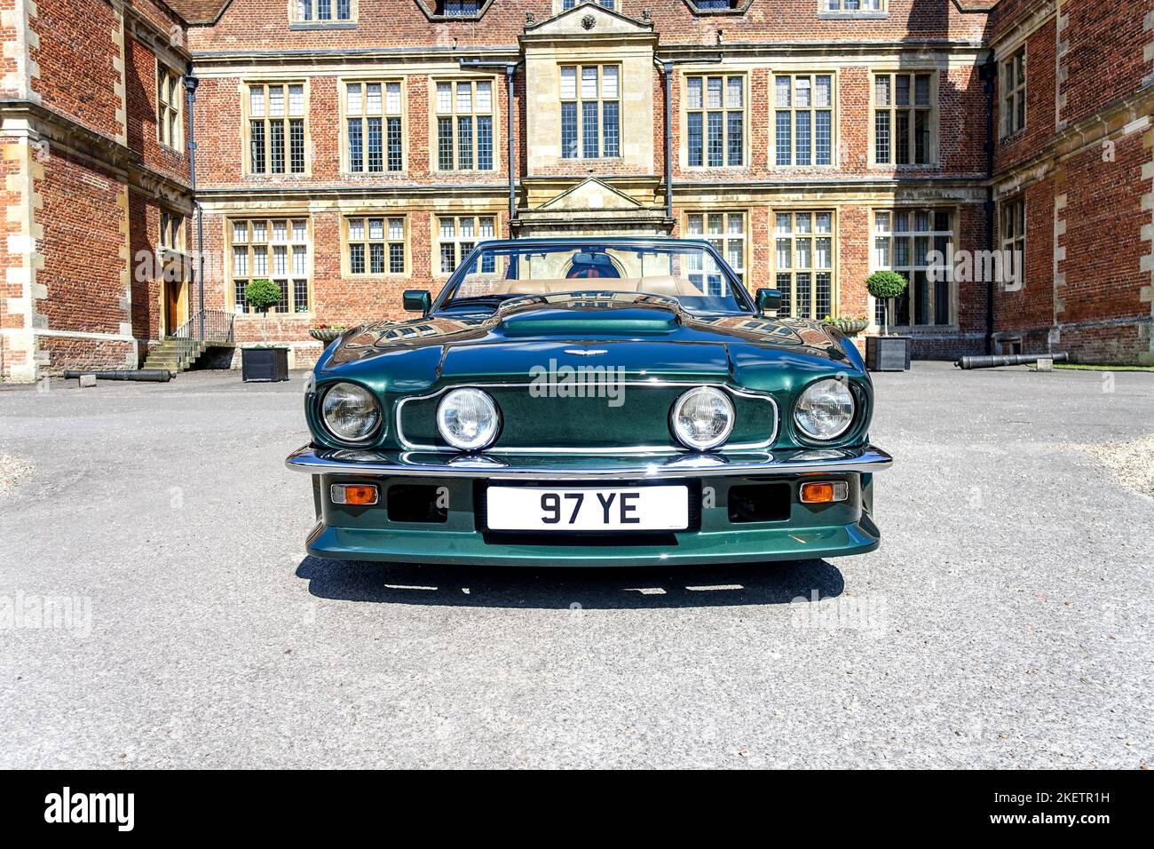Front View of an Aston Martin V8 Volante Vantage 1988 in Green in front of Shaw House, Newbury Stock Photo