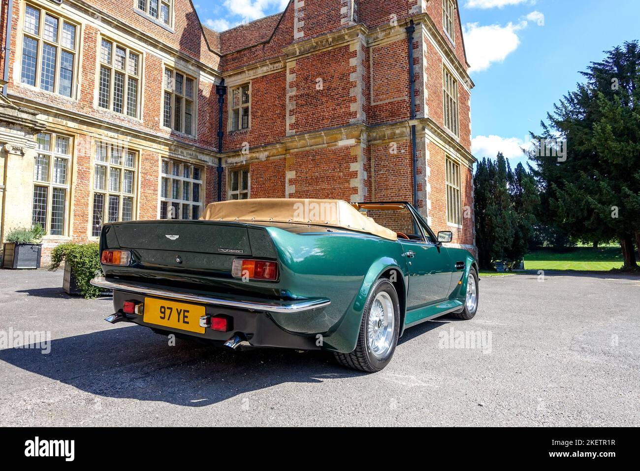 Rear View of an Aston Martin V8 Volante Vantage 1988 in Green in front of Shaw House, Newbury Stock Photo