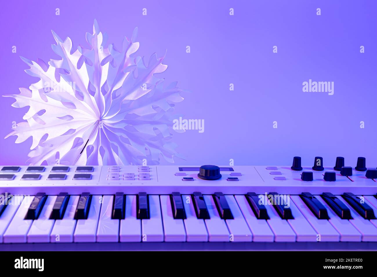 Christmas background with midi keyboard and holiday decor with neon