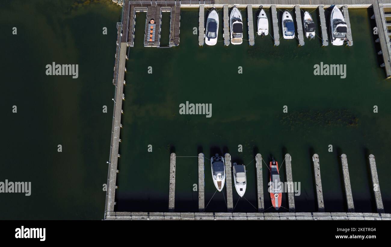 Aerial view of a marina with moored boats over green river bay Stock ...
