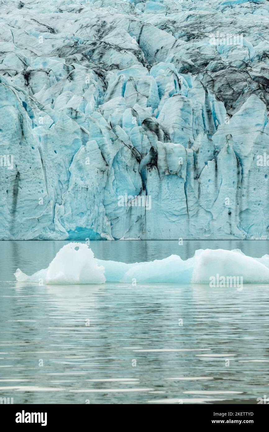 Ice wall and icebergs in Fjallsarlon glacier lagoon, abstract landscape, Iceland Stock Photo
