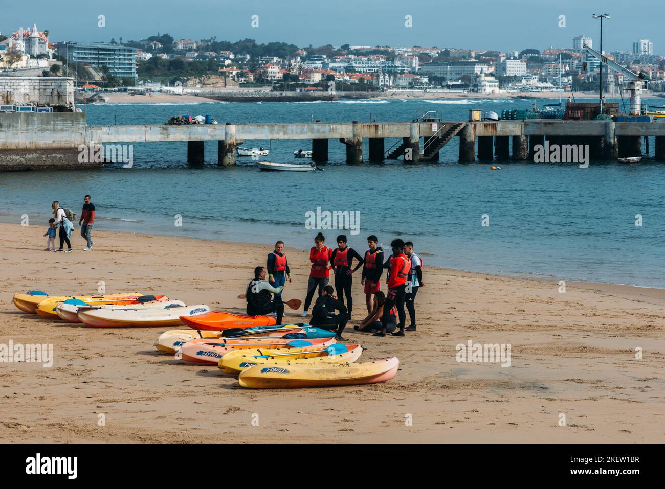 Young persons kayaking at Cascais Bay during the autumn with luxury yachts in the background Stock Photo