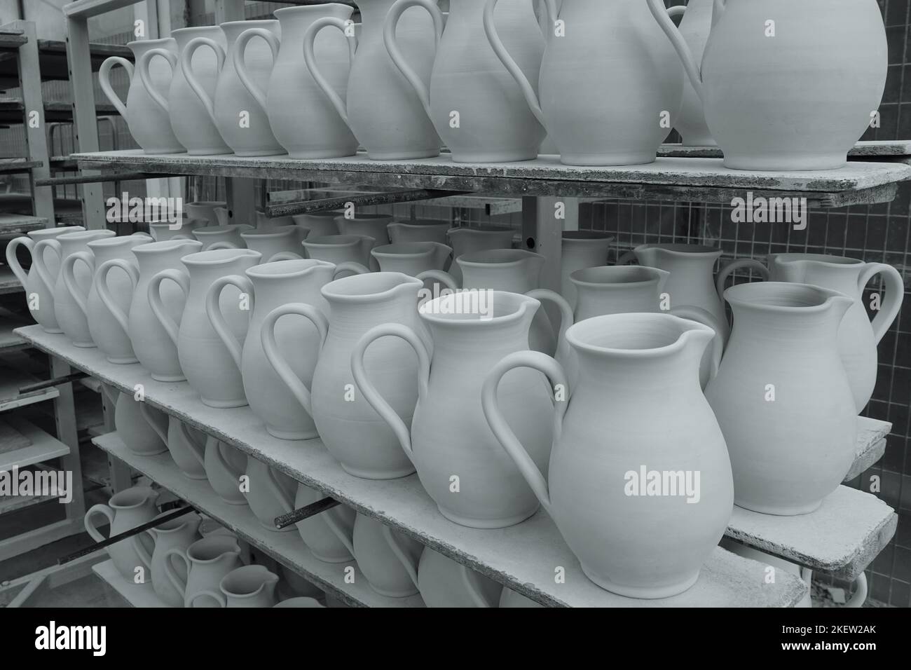 Shelves with ceramic pottery water pitchers left out to dry before