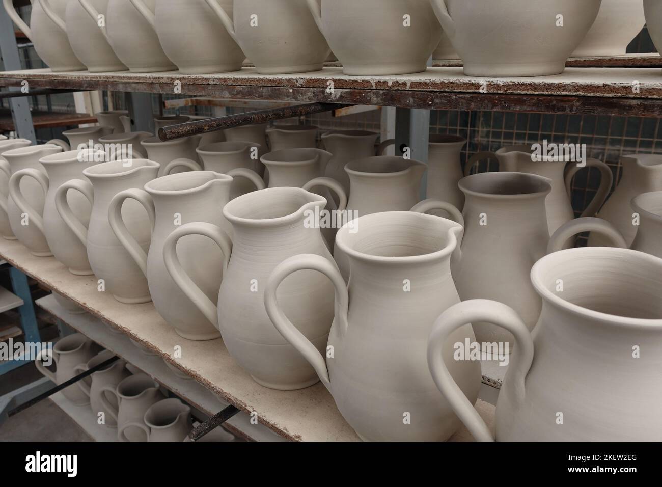 Pottery left out to dry before firing. Ceramic pitcher jugs. Stock Photo