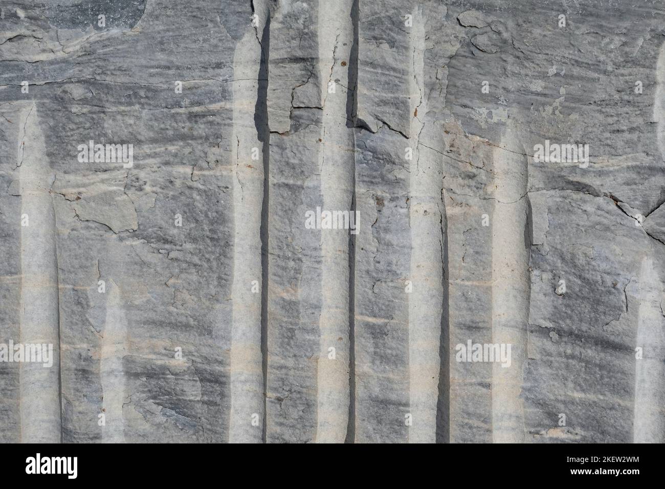 Marble block with quarry extraction cuts. Metamorphic rock background