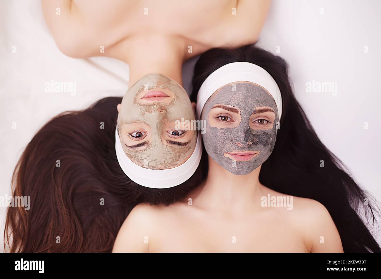Two girls are relaxing during facial mask application in spa Stock Photo Alamy