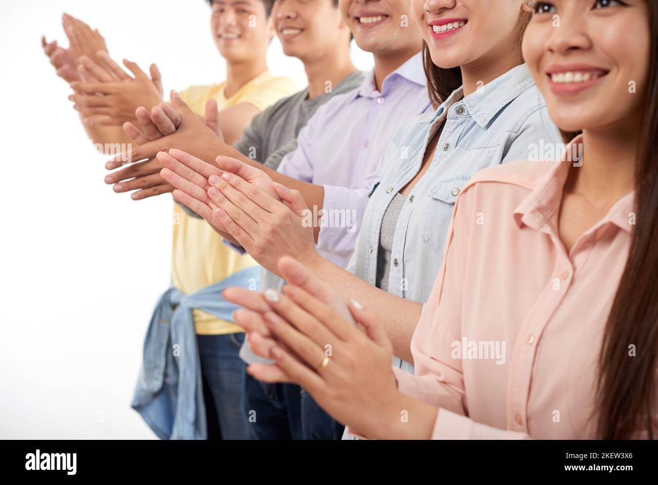 Cropped image of applauding smiling yuong people Stock Photo