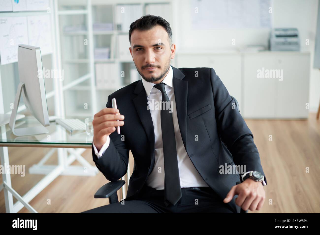 Portrait of handsome Turkish businessman in his office Stock Photo