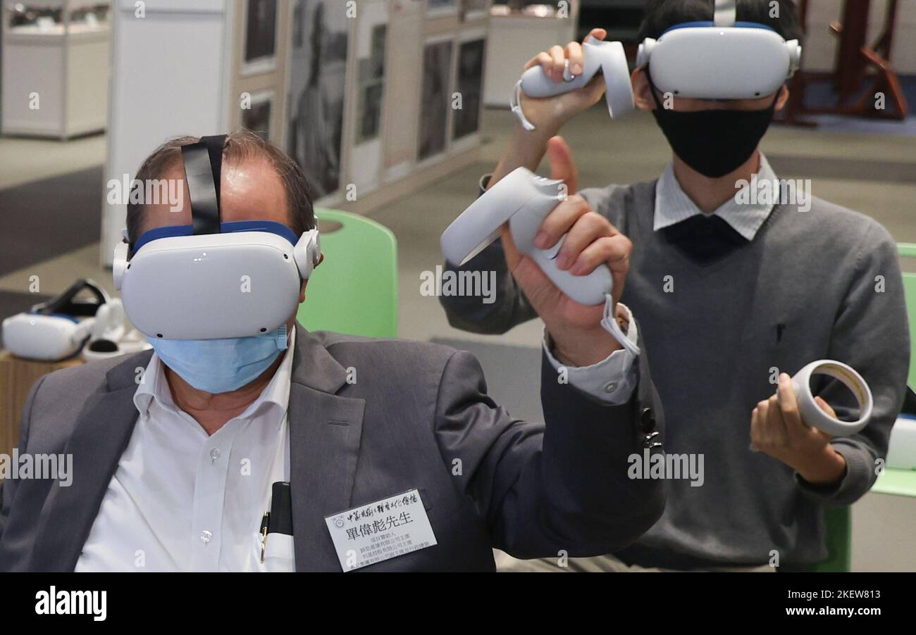 Visitors use a Virtual Reality headset at a booth during an VR