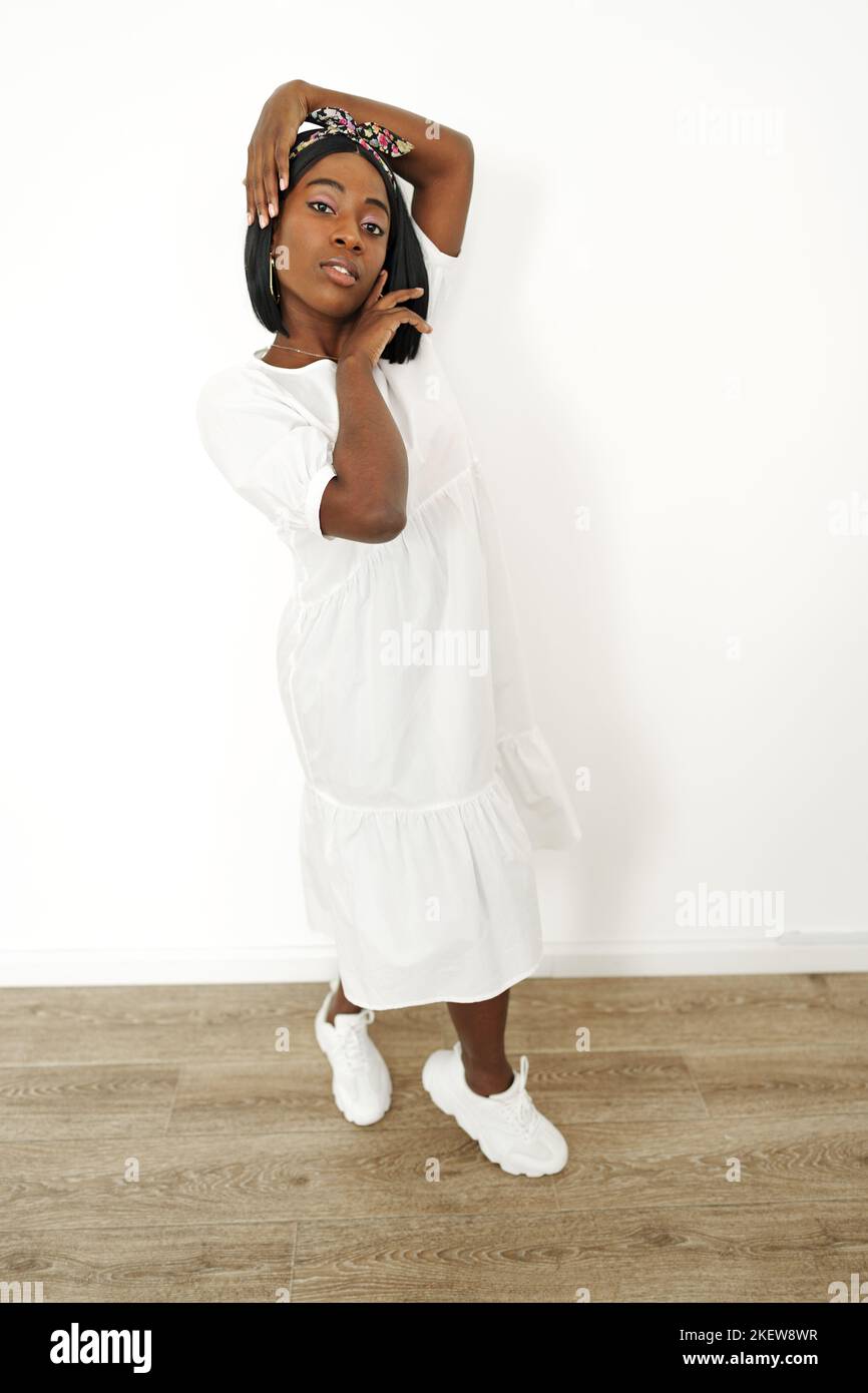 Beautiful young african woman posing over white background Stock Photo ...