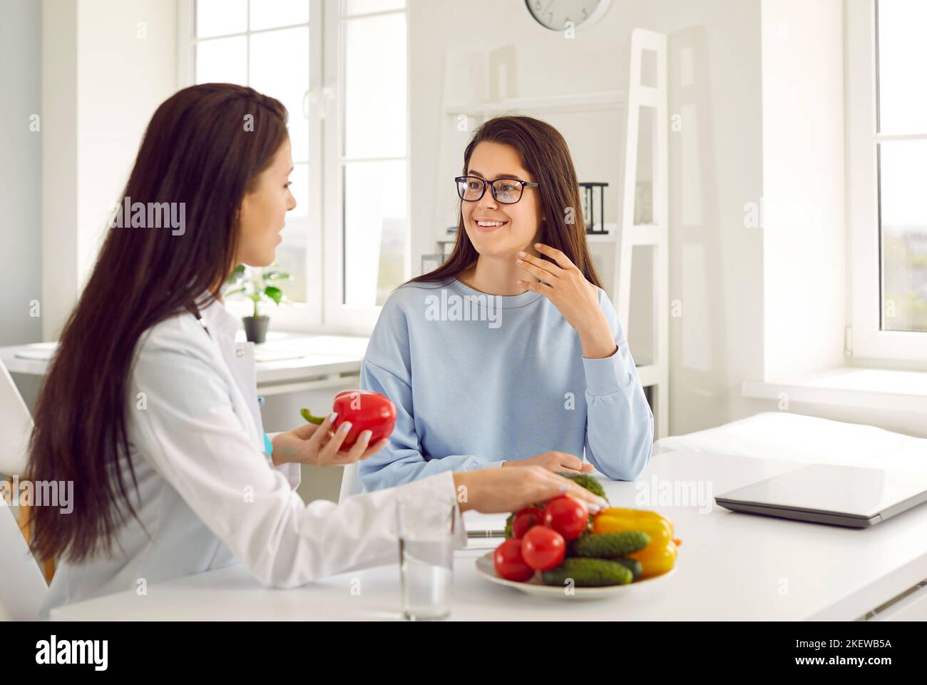 Dietitian giving dieting consultation to young woman who wants to lose some weight Stock Photo