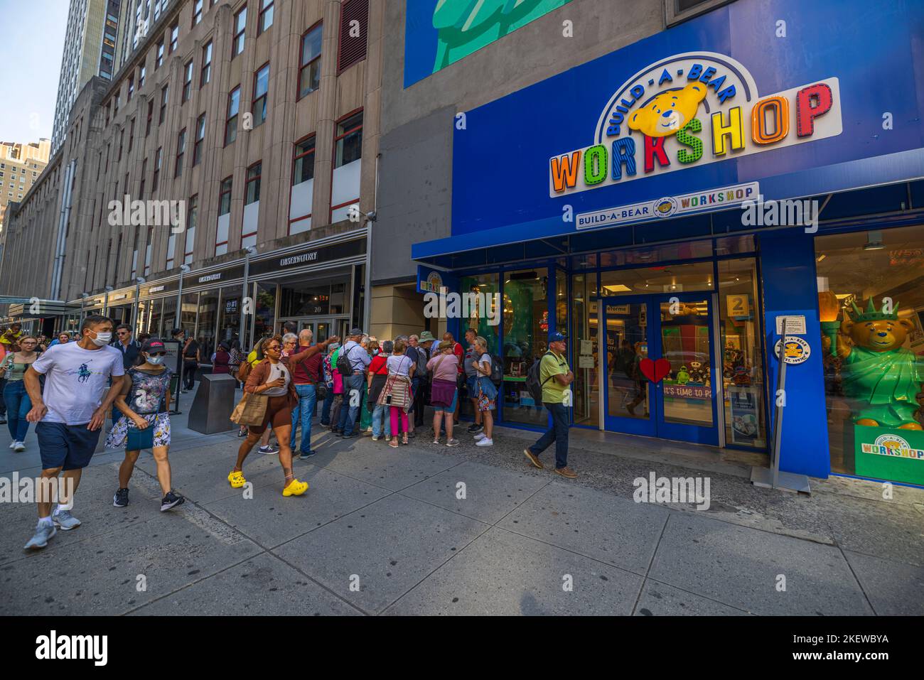 Close up view of people on street near entrance of build a bear workshop. New York, USA. Stock Photo