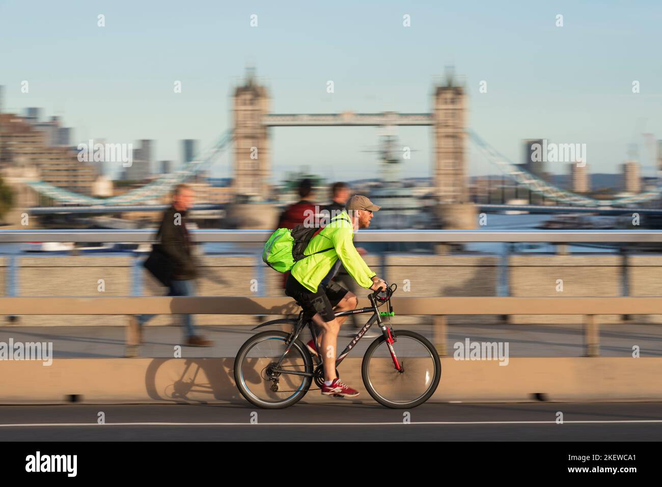A man cycling during rush hour, across London Bridge, London, UK. 18