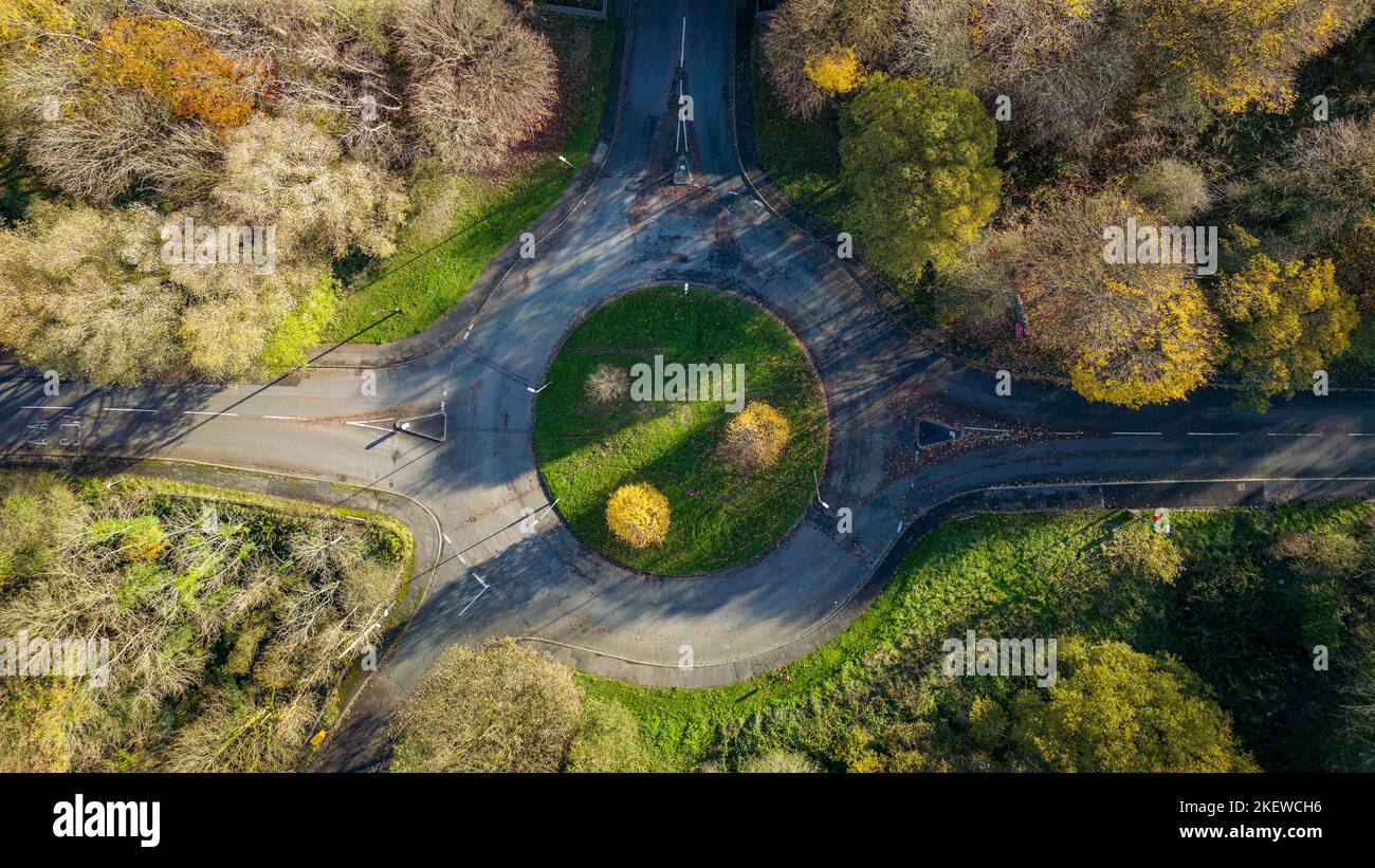 Aerial view of autumn (fall) trees and colors next to a roundabout and