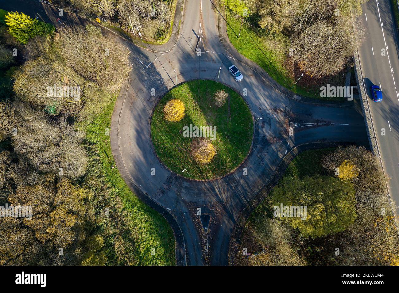 Aerial view of a traffic roundabout surrounded by autumn trees (Wales, UK) Stock Photo