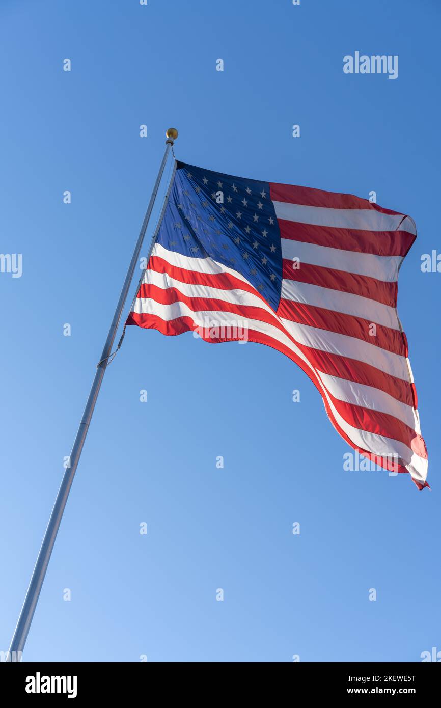 The Stars and Stripes, waving in the wind, is a symbol of freedom and democracy the world over. Stock Photo