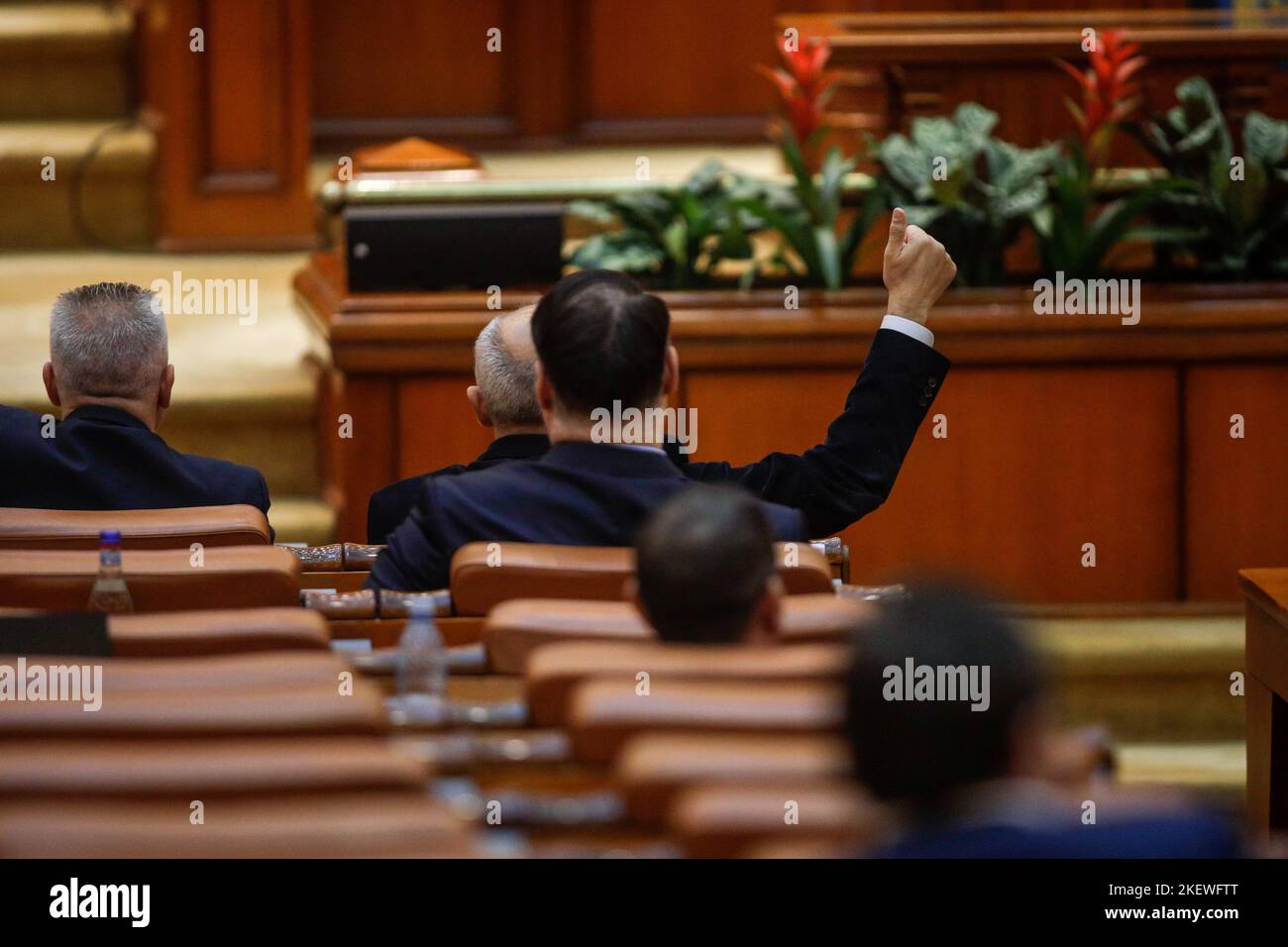 Bucharest, Romania - November 14, 2022:  Romanian member of parliament gestures to his colleagues how to vote on bills. Stock Photo