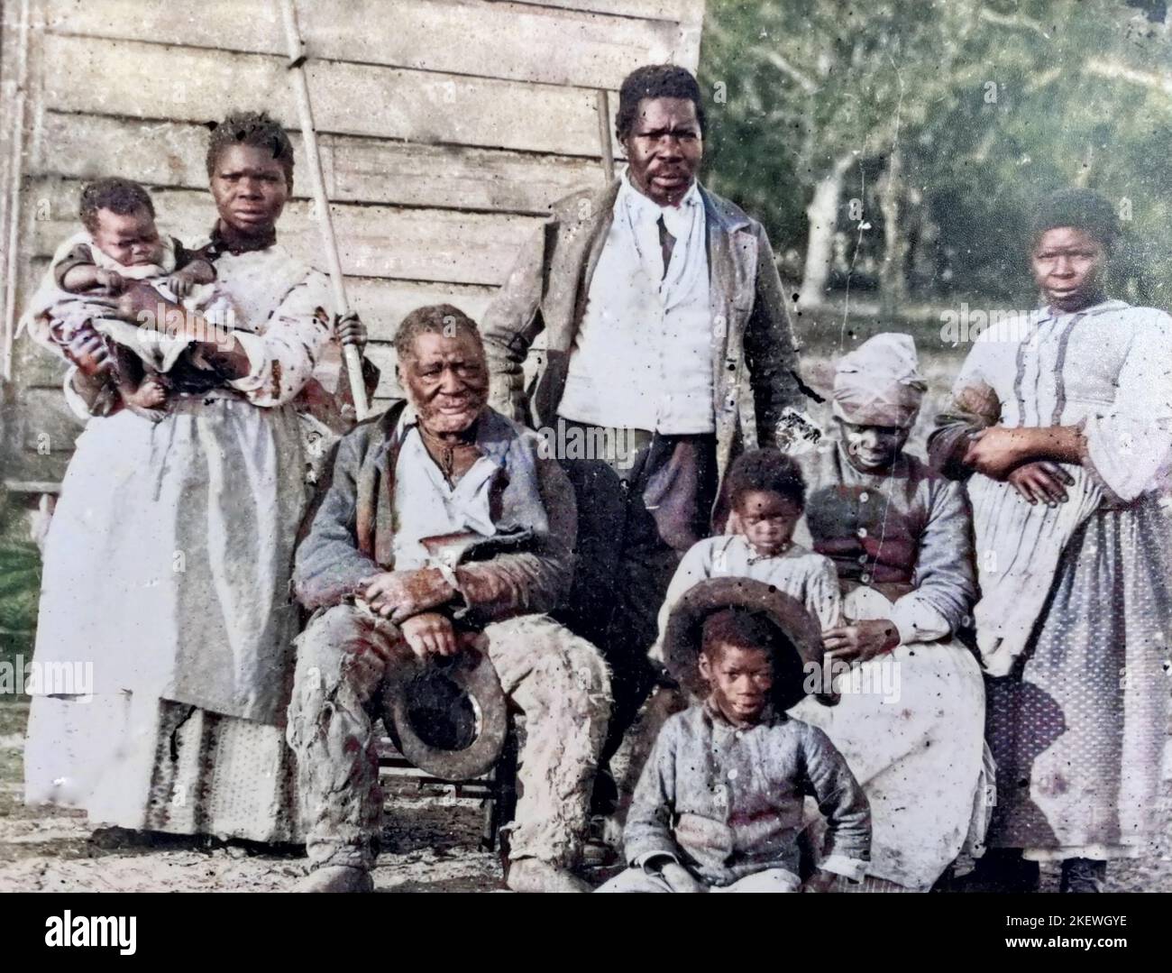 FORMER SLAVE FAMILY in South Carolina. Photo by Irish-American photographer Timothy O'Sullivan (1840-1882) after Union forces  captured the Sea Island coastal area of the state. Colourised image. Stock Photo