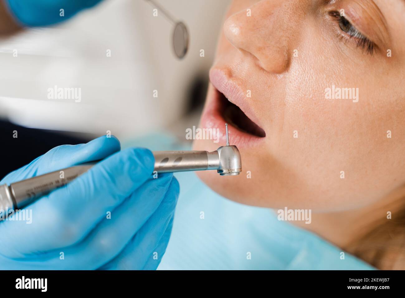 Dental drill closeup. Dentist drilling teeth of woman in dentistry