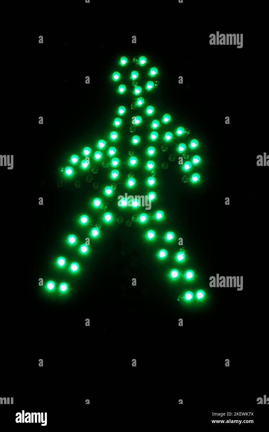 Detail of traffic light. Figure of green man, sign for pedestrians