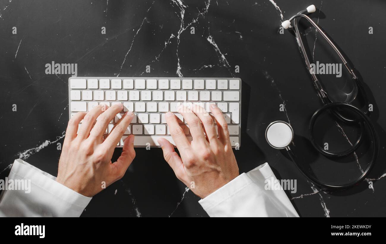 Doctors Keyboard Doctor typing on keyboard with copy space Stock Photo - Alamy