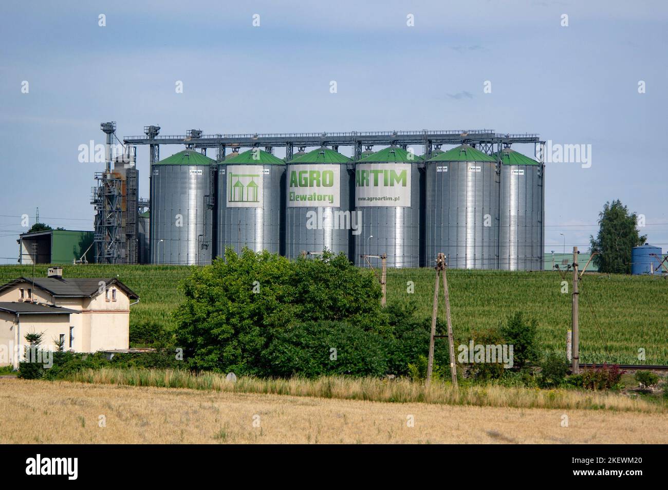 WARLUBIE, POLAND - JULY 29, 2022: Agro Artim Elewatory buildings of company producing raw material storehouses with 10 silo elevators Stock Photo
