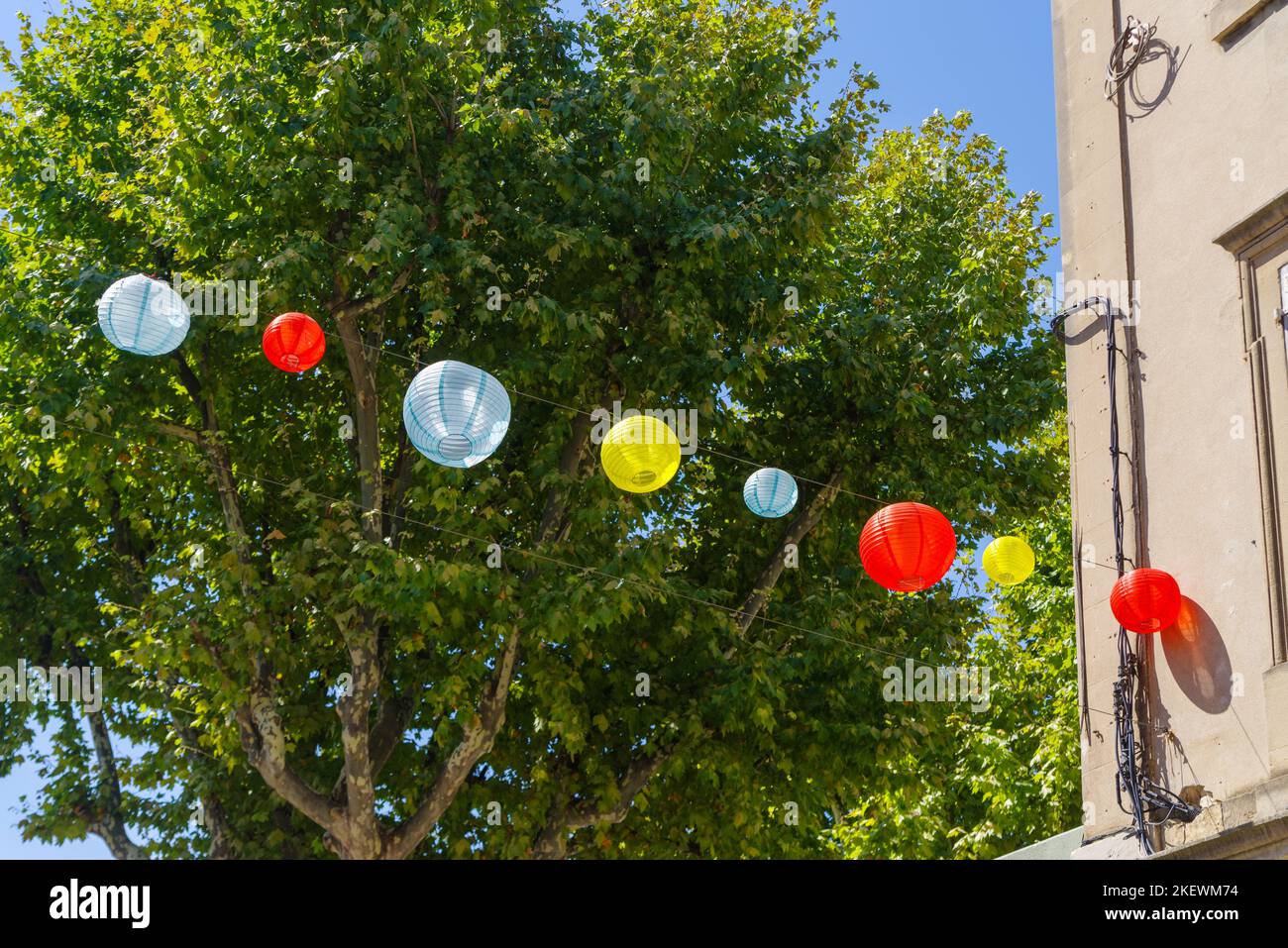 colorful balloons hanging in the streets of Arles, France Stock Photo