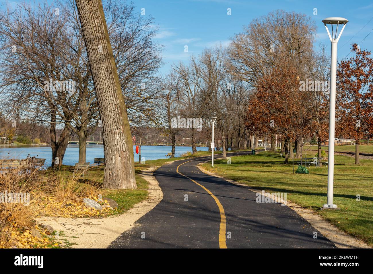 Bike trail and walking path along the rock river on a sunny late fall day.  Rockford, Illinois, USA. Stock Photo