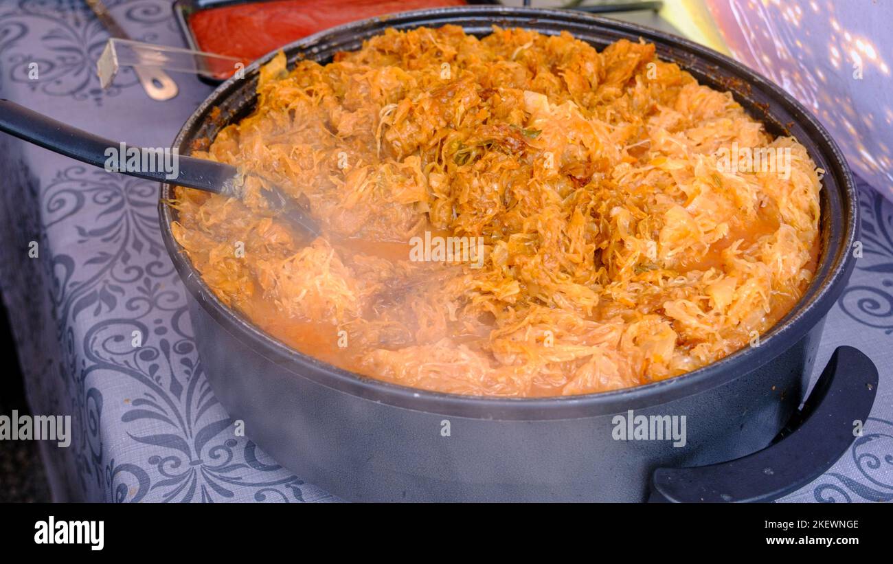 Traditional rustic cabbage stew, cooking in a large cooking pot on the