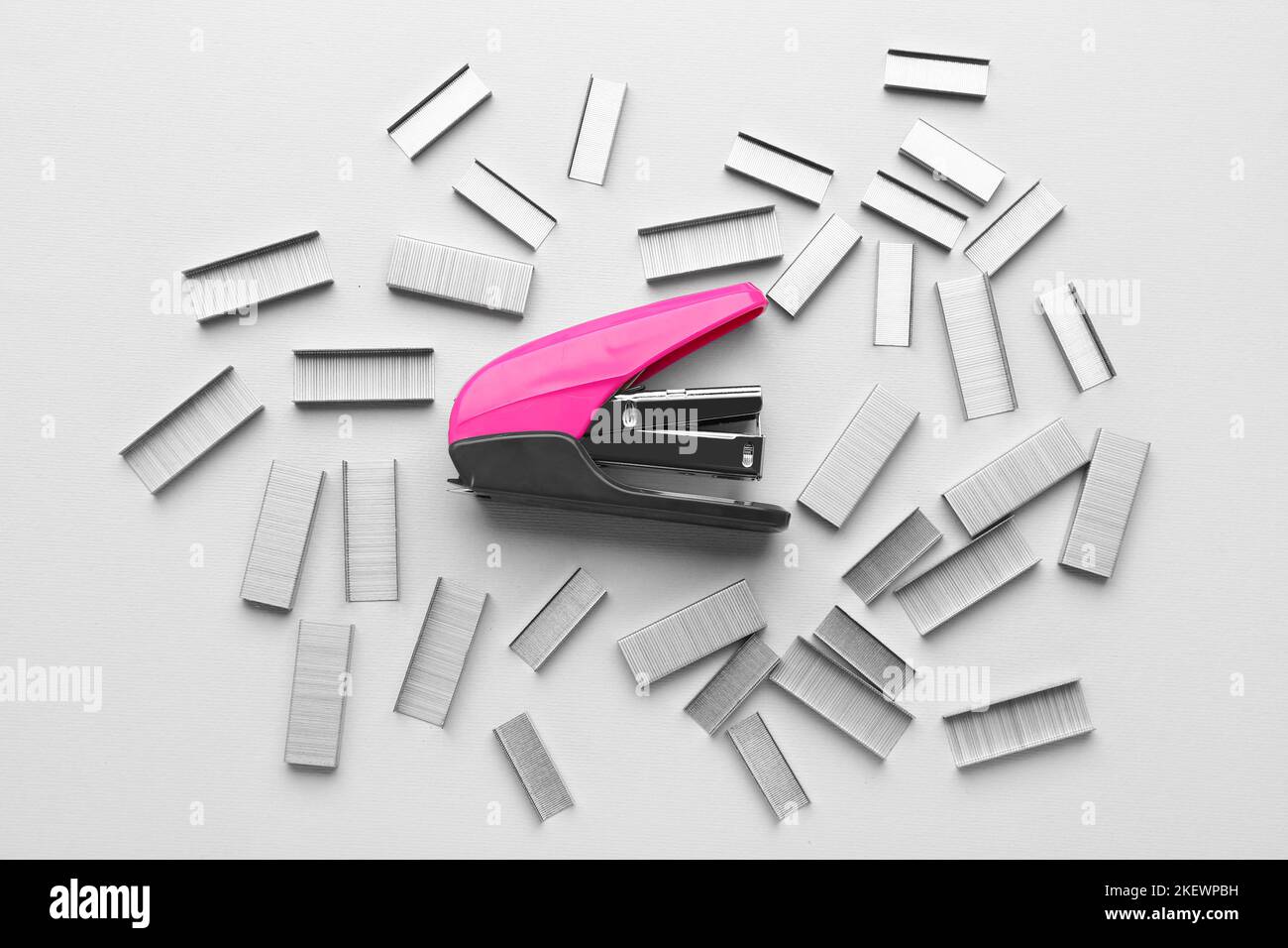 Pink office stapler with staples on light background Stock Photo - Alamy
