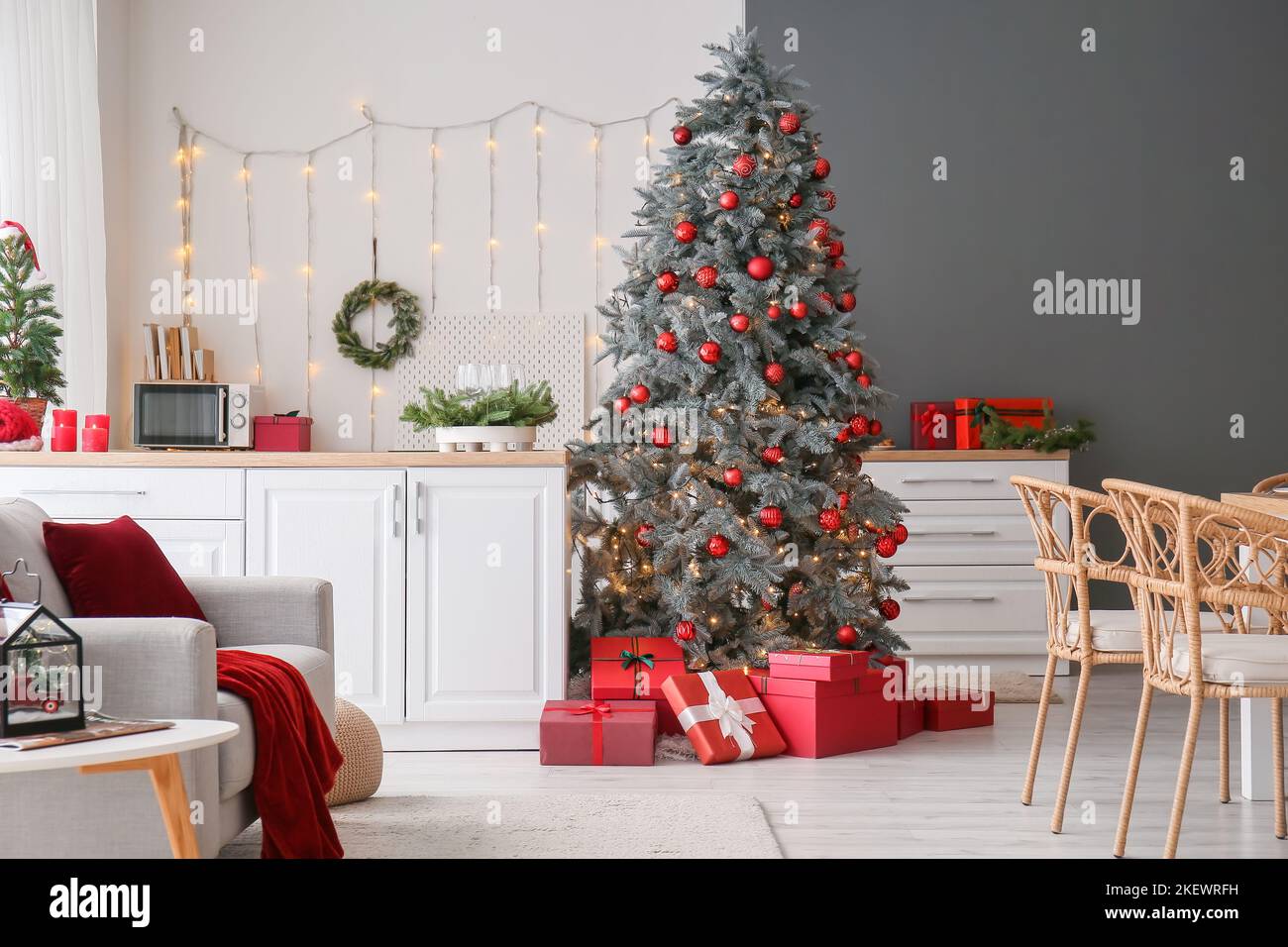 Interior of kitchen with Christmas tree and white counters Stock Photo