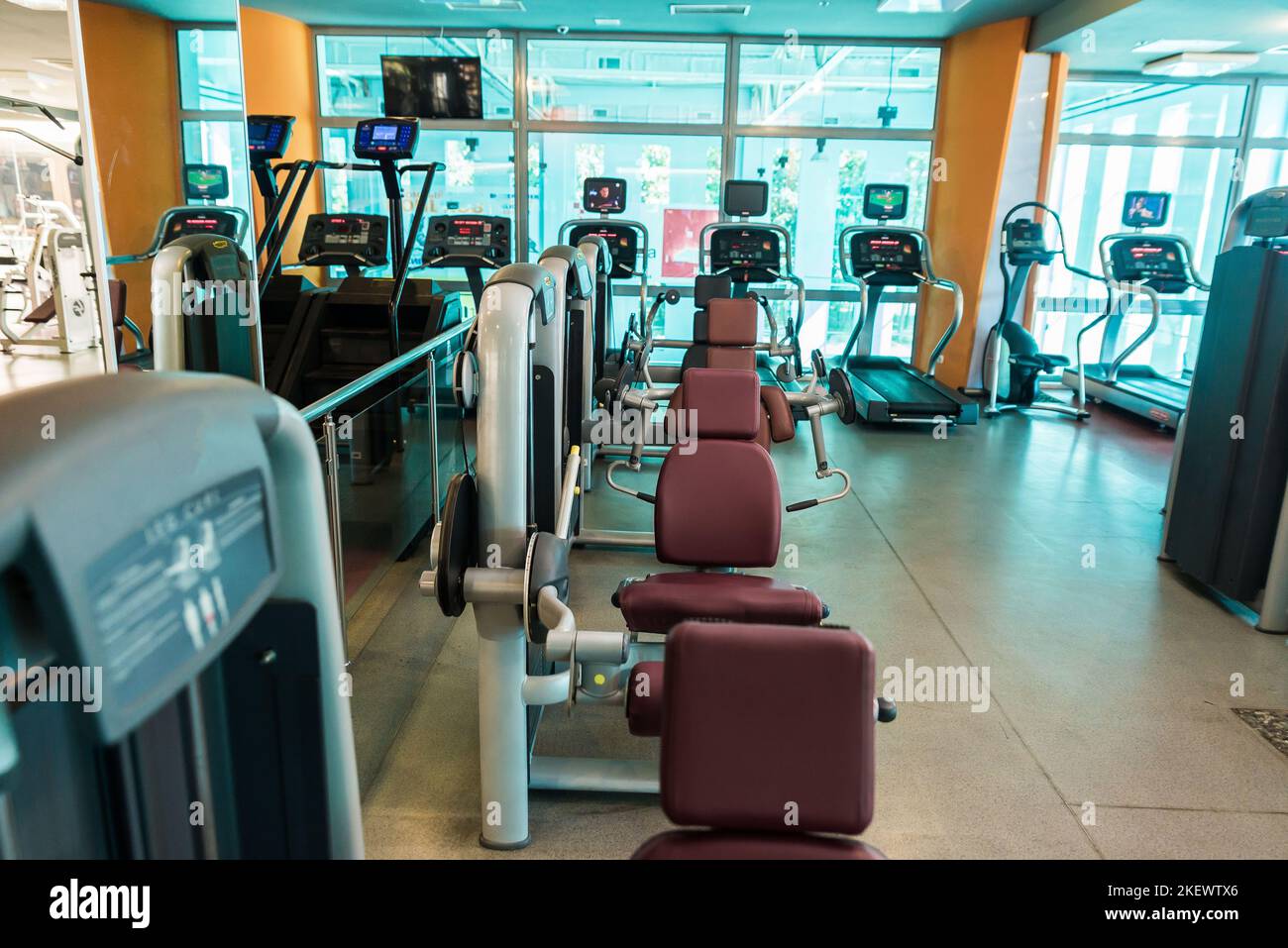 Interior of modern gym fitness room with large windows and treadmills ...