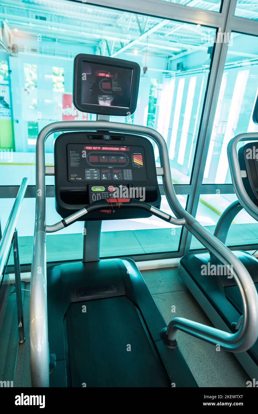 Interior of modern gym fitness room with large windows and treadmills ...
