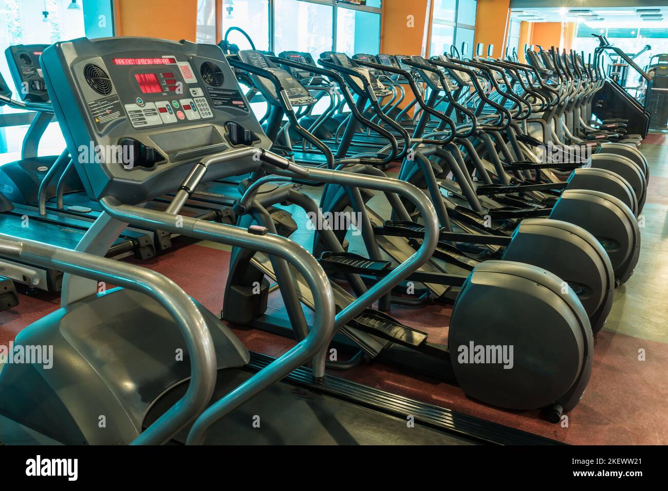 Interior of modern gym fitness room with large windows and treadmills ...