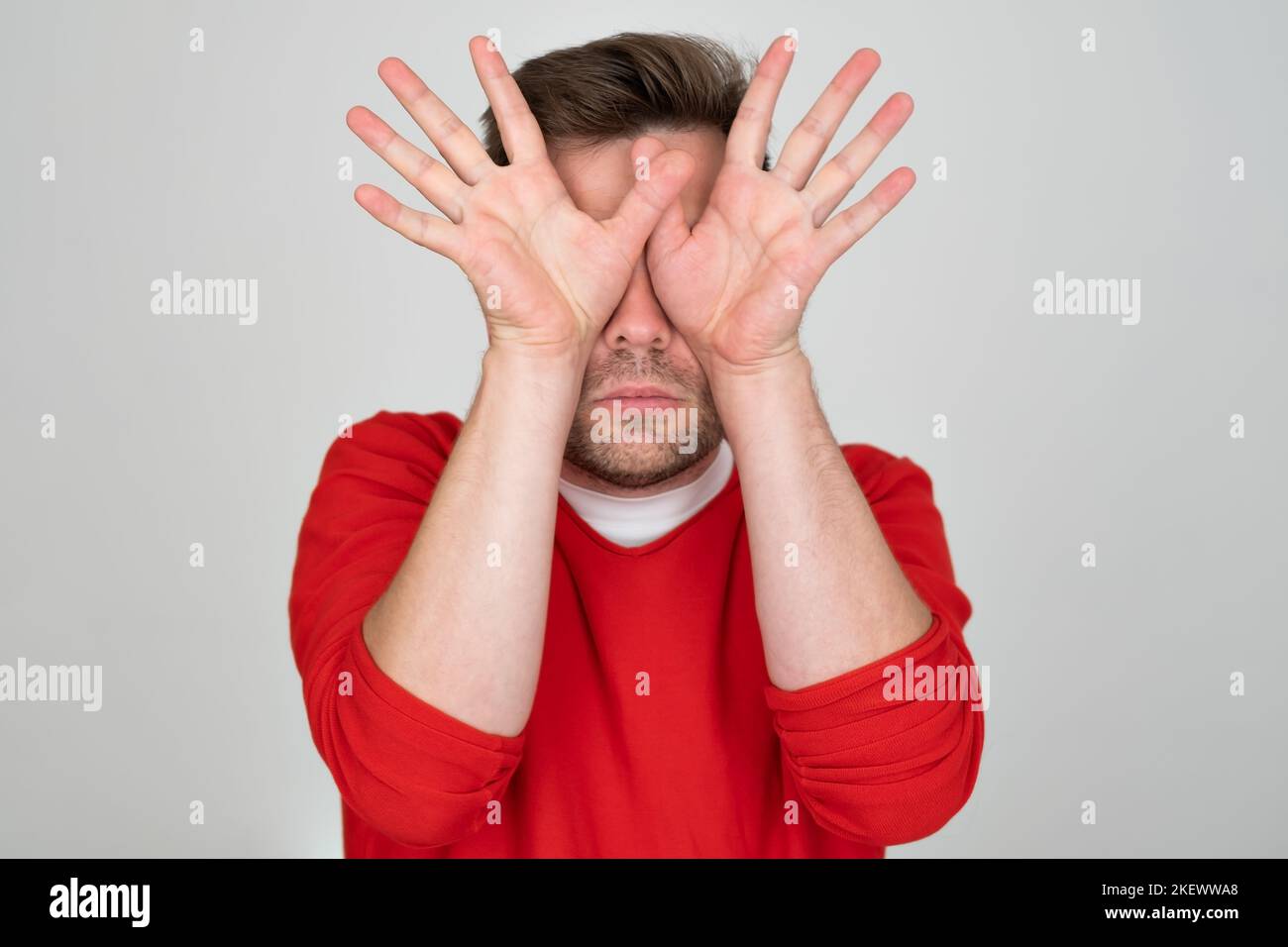 See nothing. Handsome young man covering eyes with hands Stock Photo ...
