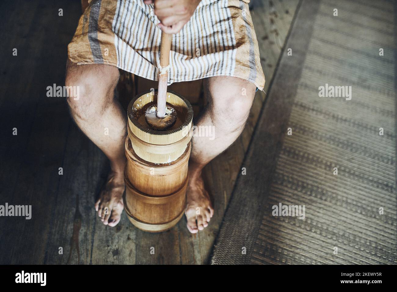 Man making butter with butter churn. Old traditional method making of