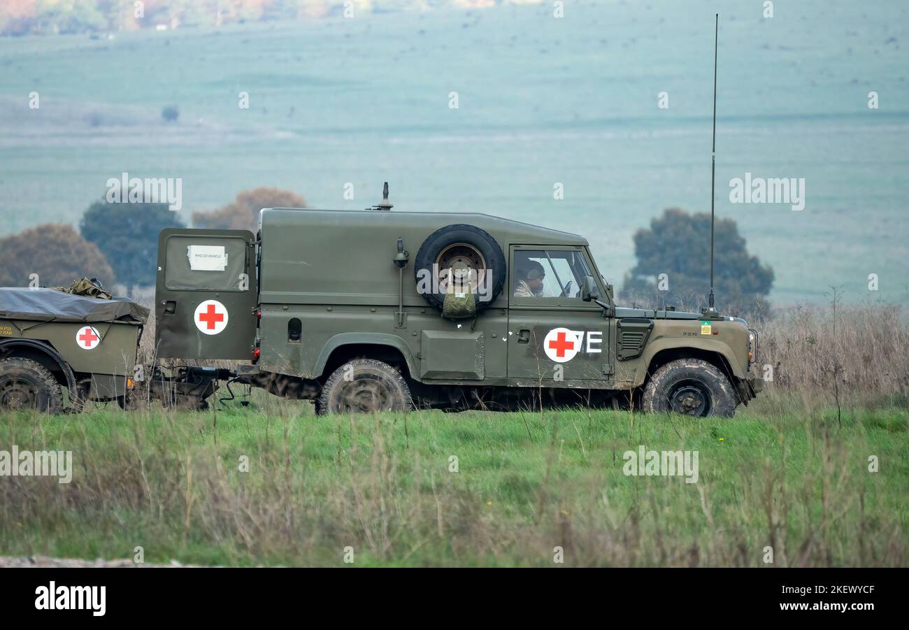 British army Land Rover Defender Wolf ambulance with trailer on a military exercise, Wiltshire UK Stock Photo