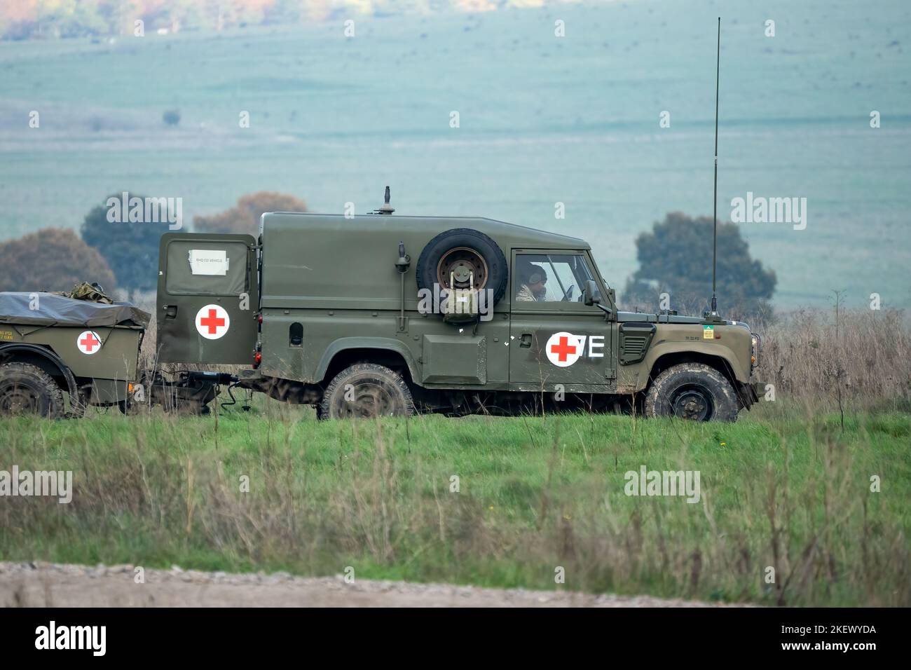 British army Land Rover Defender Wolf ambulance with trailer on a military exercise, Wiltshire UK Stock Photo