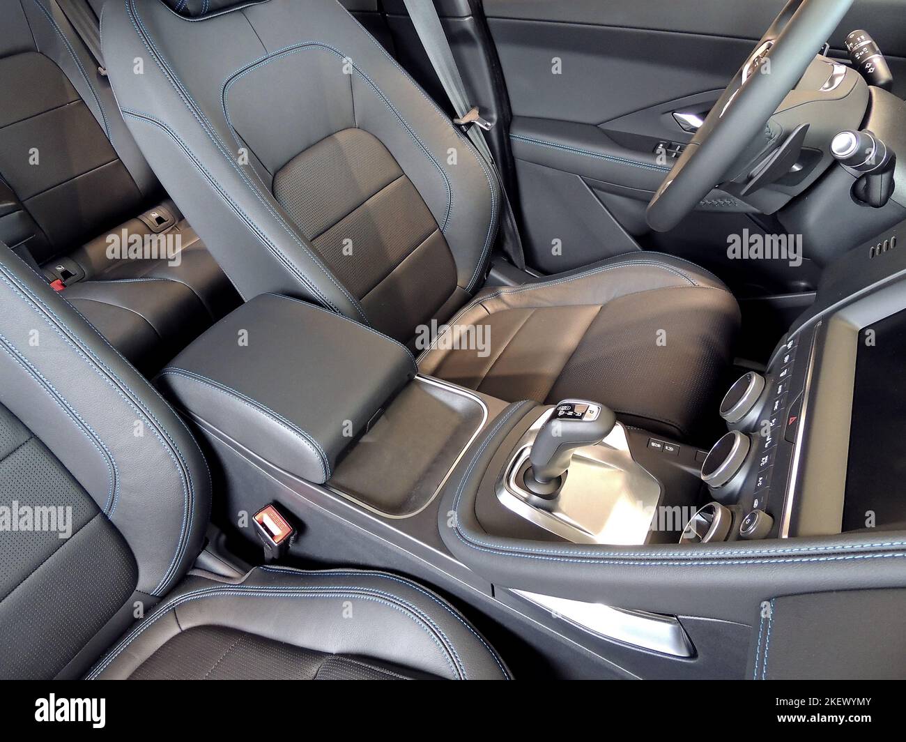 Blue thread stitched leather on seats and armrest in car interior Stock