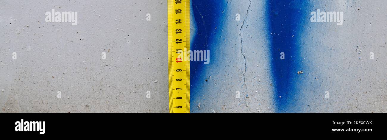 Measuring ruler on a concrete wall texture. The concept of renovation ...