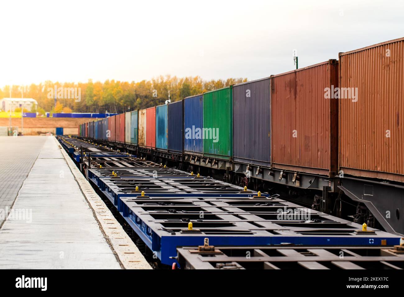 Freight train. Cargo containers transportation by railway. Impoert export logistics concept. Shipping by train. Cargo train platform. Stock Photo