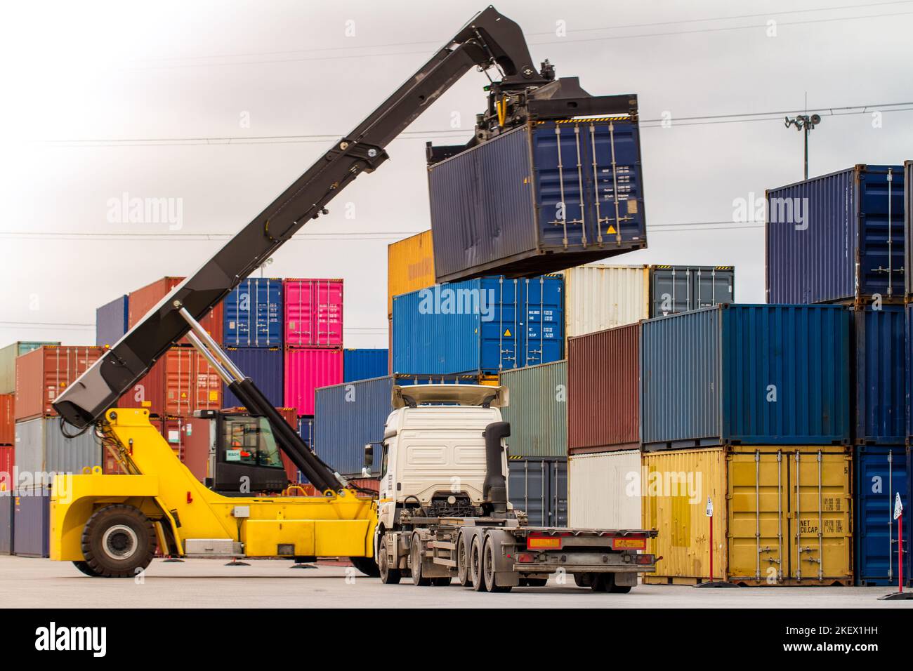 Truck while loading in logistic shipping yard with cargo container ...